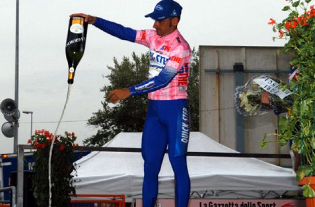 Bettini makes a nice gesture on the podium. I'm not in the mood for champagne. Photo copyright Fotoreporter Sirotti.