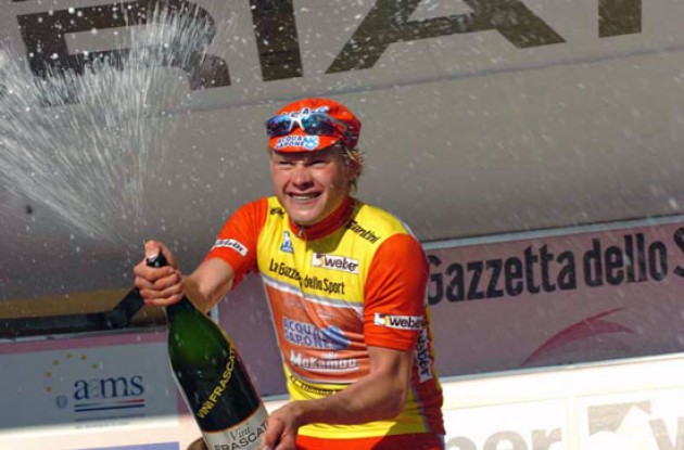 A joyful Arekeev taking a shower on the podium.