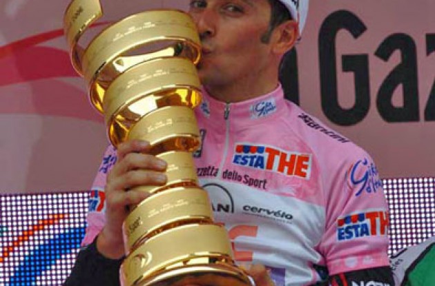 Ivan Basso (Team CSC) celebrates his Giro d'Italia win on the podium. Photo copyright Fotoreporter Sirotti.