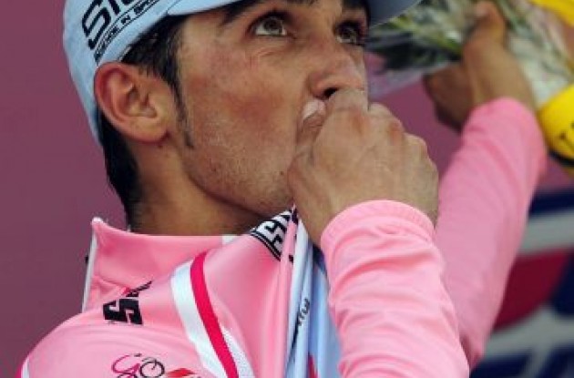Alberto Contador kisses the maglia rosa on the podium at the top of Mount Etna. Photo Fotoreporter Sirotti.
