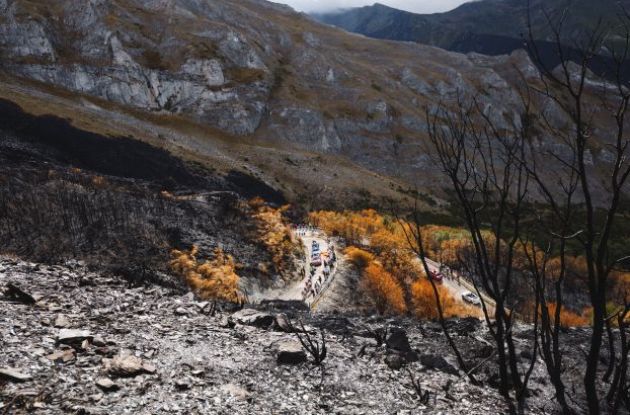 | Unipublic Cyclists climbing burnt mountain after forest fires in Spain