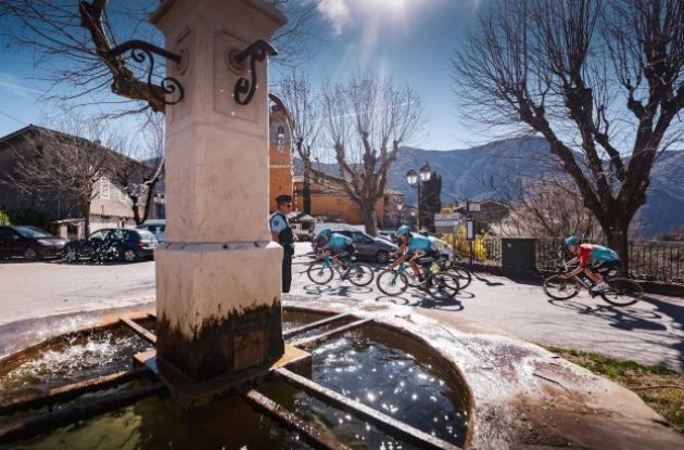 Paris-Nice riders riding past fountain in stage 7