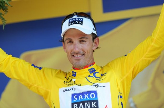 Fabian Cancellara (Team Saxo Bank) on the podium in yellow. Photo copyright Fotoreporter Sirotti.