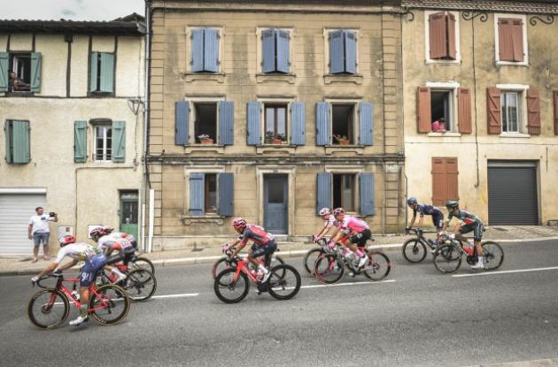 French houses with cyclists in front of them