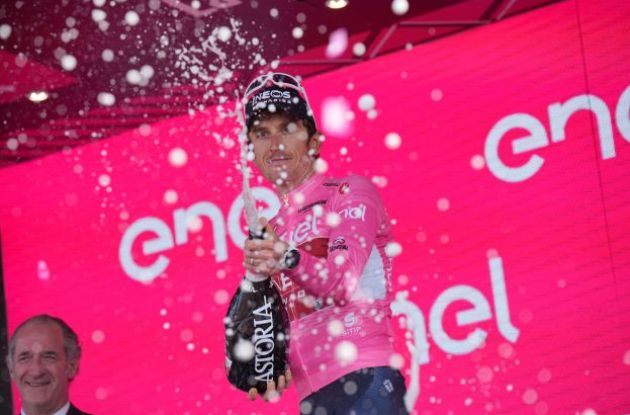 Geraint Thomas celebrates his Giro d'Italia lead with champagne on the podium
