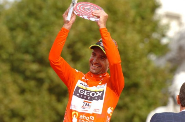 Juan Jose Cobo Acebo with the winner's trophy on the podium in Madrid, Spain. Photo Fotoreporter Sirotti. Juan Jose Cobo Acebo with the winner's trophy on the podium in Madrid, Spain. Photo Fotoreporter Sirotti.