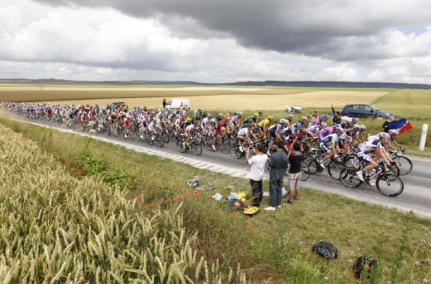 The Tour de France peloton passes through the French landscape. Photo Fotoreporter Sirotti. The Tour de France peloton passes through the French landscape. Photo Fotoreporter Sirotti.