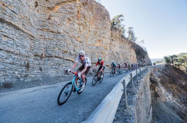 Paris-Nice riders passing rock formation on their bikes