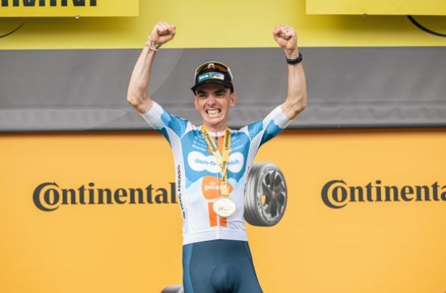 Romain Bardet celebrates on the podium | A.S.O. Romain Bardet waving on the Tour de France podium after winning stage 1