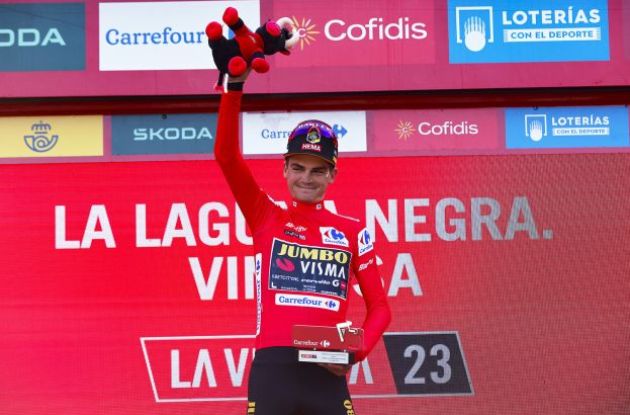 Sepp Kuss is celebrated on the podium as general classification leader