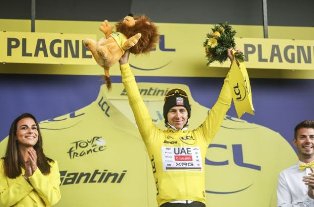 Tadej Pogacar celebrating his Tour de France lead on the podium