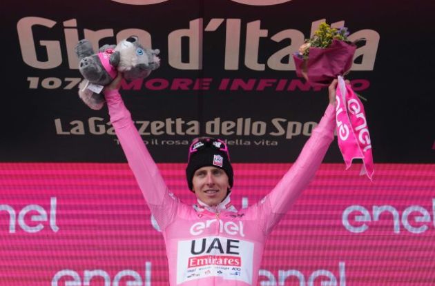 Tadej Pogacar celebrates his Giro d'Italia lead in the pink jersey on the podium