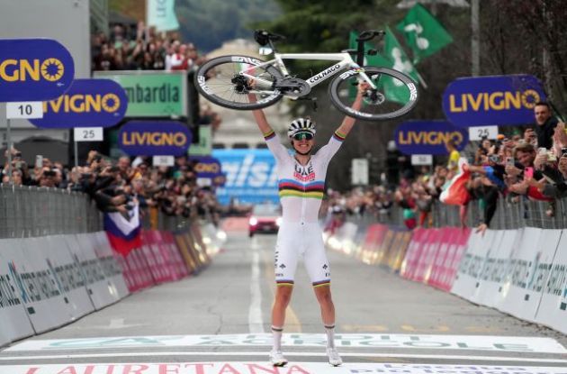 Tadej Pogacar raising his Colnago bike above his head