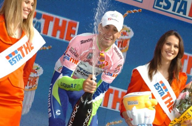 Vincenzo Nibali celebrates his overall lead doing some spraying with the beautiful podium girls on the podium in Cuneo, Italy. Photo copyright Fotoreporter Sirotti.