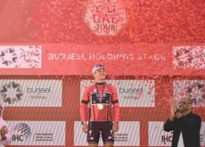 Remco Evenepoel on the podium wearing the leader's jersey