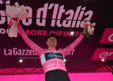 Andreas Leknessund on the podium wearing the pink jersey as leader of Giro d'Italia 2023