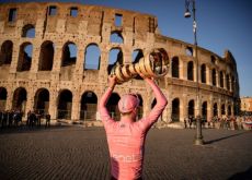 Tadej Pogacar with Giro d'Italia trophy in front of the Colosseum in Rome