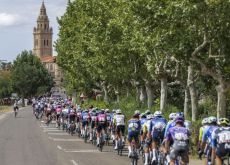 | Unipublic Cycling peloton with church in background