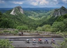 Cyclists passing French landscape