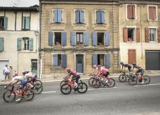 French houses with cyclists in front of them