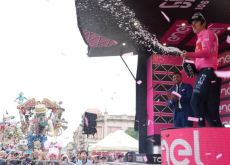 Geraint Thomas celebrates his Giro d'Italia lead with champagne on the podium