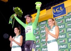 Mark Cavendish celebrates his lead in the green points competition on the podium with the beautiful French podium girls. Photo Fotoreporter Sirotti.