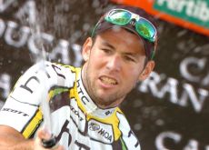 Mark Cavendish celebrates his stage win on the podium. 
Photo copyright Fotoreporter Sirotti.