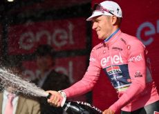 Remco Evenepoel celebrates his Giro d'Italia lead on the podium