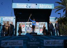 Primoz Roglic waves the Tirreno-Adriatico trident trophy on the podium